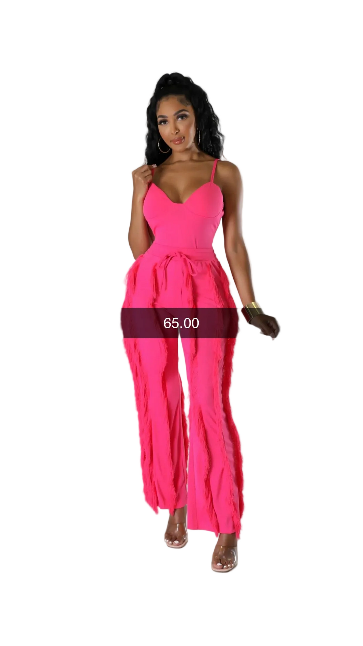 A woman modeling a bright hot pink sleeveless jumpsuit with thin straps, a sweetheart neckline, a tie-waist belt, and wide flared legs, photographed against a light gray studio background.